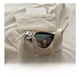 Interior view showing the storage capacity of a cream white minimalist shoulder bag