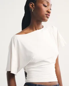 Detail view of women's white batwing sleeve top with gathered ruched waist detail