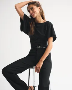 Close-up showing the elegant batwing sleeve and waist pleats on this black T-shirt.