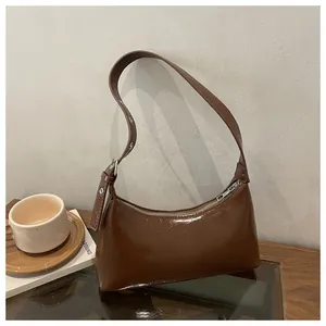 Chic brown glossy underarm shoulder bag for women with a sleek minimalist design