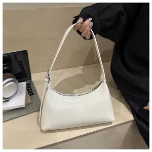 Chic cream white underarm hobo bag with smooth leather finish in lifestyle setting
