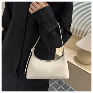 Chic white underarm shoulder bag for women, minimalist baguette style in glossy finish.