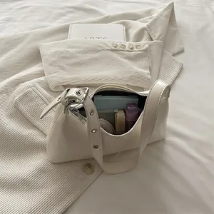 Elegant white underarm shoulder bag for women with stylish silver buckle details