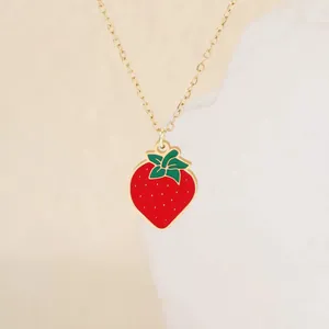 Cute red enamel strawberry pendant necklace on a gold clavicle chain for summer