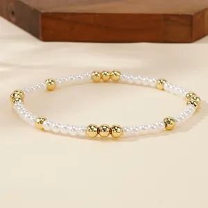 Elegant white imitation pearl stretch bracelet with gold accent beads for women's style