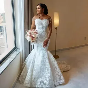 Elegant heavy lace mermaid wedding dress with pearl sleeve details and a slim fit silhouette.