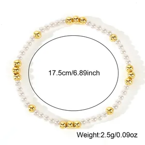 Minimalist stretch bracelet featuring white imitation pearls and gold accent beads