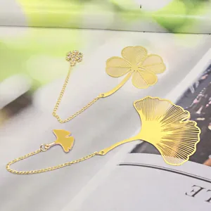 Detailed macro view of gold hollow metal bookmarks with ginkgo and clover leaf vein designs