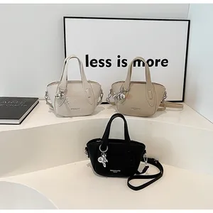 Three lychee texture handbags in white, beige and black with cute rabbit charms