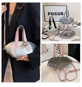 Detailed views of metallic silver handbag with pink handles and balloon dog charm