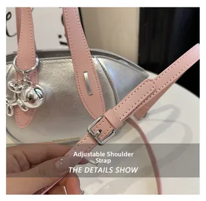 Close-up showing the pink adjustable leather shoulder strap and silver metal buckle detail