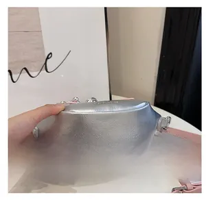 Detailed macro view showing the bottom texture of a silver metallic bucket bag