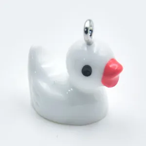 Detailed view of a white resin cartoon duck pendant with a metal loop for DIY accessories