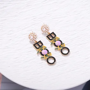Unique Halloween BOO dangle earrings with spider motif and pearl-studded accents.