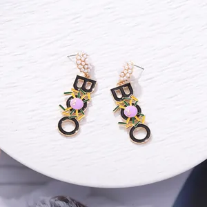 Detailed view of Halloween BOO earrings with spider design and pearl studs.