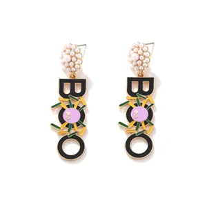 Halloween spider earrings with pearl clusters and BOO letter charms in drip oil