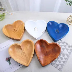 Detailed view of handcrafted heart-shaped wooden prayer bowls in various finishes