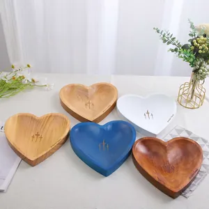Set of 5 handmade heart-shaped wooden prayer bowls in assorted natural and painted finishes.