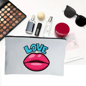 Detail view of white cotton linen makeup bag with vibrant LOVE and pink lips print