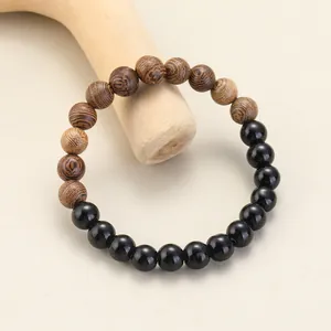 Detailed view of an elegant beaded bracelet with wooden texture and black onyx beads
