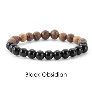 Detailed view of natural black obsidian and wood grain beaded stretch bracelet.