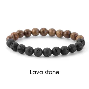 Close-up detail of handmade natural black lava stone and brown wood bead bracelet
