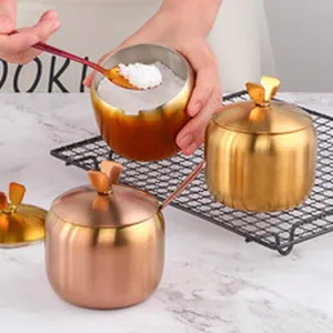 Apple-shaped stainless steel seasoning jars with spoons in gold and rose gold finishes