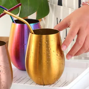 Set of colorful stainless steel egg shaped wine tumblers with reusable metal straws