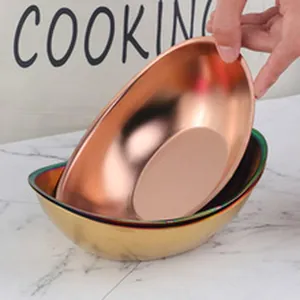 Close-up detail of elegant stainless steel oval serving bowls in rose gold finish
