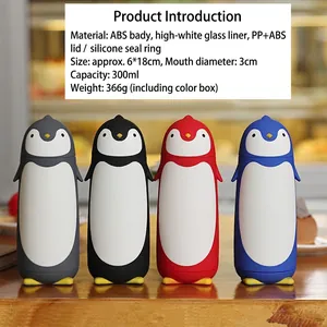 Four colorful penguin-shaped double-walled glass water bottles on a wooden table.