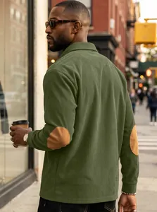 Men's green corduroy polo shirt with brown elbow patches and ribbed texture details.