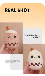 Detail shot of cute boba tea plush keychains in brown and cream with sweet faces.
