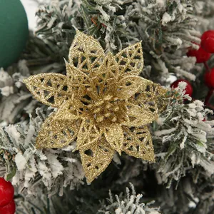 Close-up of gold glitter hollow-out poinsettia flower for Christmas tree decor