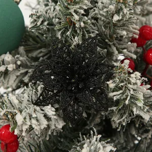 Close-up of a black glitter hollowed-out Poinsettia flower for Christmas tree decor