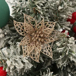 Close-up of a gold glittery hollow poinsettia flower for Christmas tree decoration