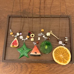 Handmade long necklace with colorful fruit pendants like orange, kiwi, and watermelon