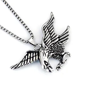 Macro view of a stainless steel eagle pendant necklace for men with carved feather details