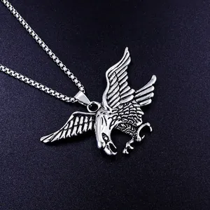 Detailed macro view of a silver stainless steel eagle pendant on a square box chain