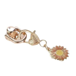 Zinc alloy sunflower keychain charm with heart detail and rose gold finish for bags