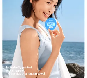 Asian woman holding compact disposable compressed towel at the beach