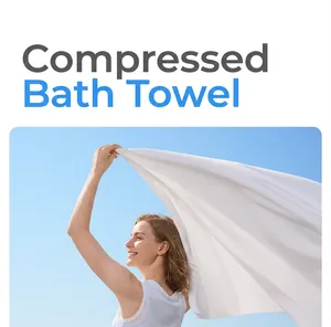 Close-up action shot of a soft white disposable compressed bath towel under blue sky