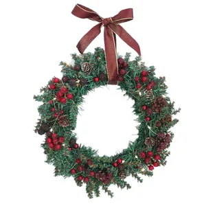 Traditional Christmas wreath with red berries, pine cones, and a burgundy ribbon bow