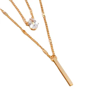 Double-layered gold-tone necklace featuring water drop crystal and vertical bar pendant
