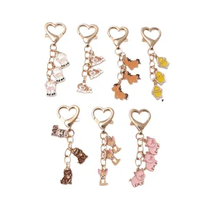 Cute cartoon animal keychain set for bags featuring heart-shaped gold lobster clasps