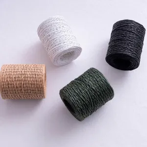 Macro view of textured paper twine rolls in multiple colors for gift wrapping
