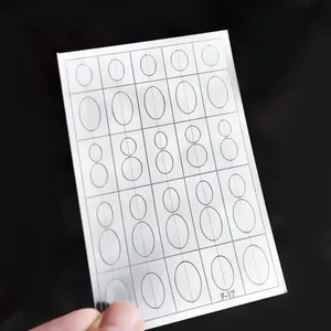 Close-up of translucent oval nail art stencil sticker for French manicure design