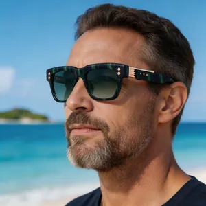 Close-up of man wearing retro square polarized sunglasses on a sunny beach background