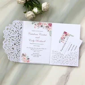 Detailed view of elegant white laser cut rose wedding invitation with floral RSVP card