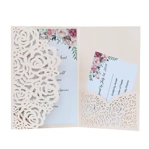 Macro view of laser-cut rose pattern wedding invitation with insert card details