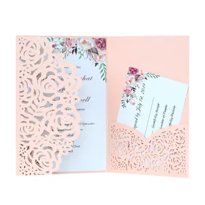 Detail view of pink laser cut wedding invitation with floral insert and RSVP card